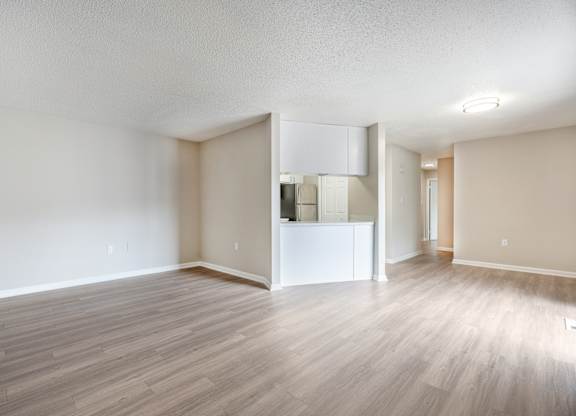 A room with a white cabinet and a white wall.