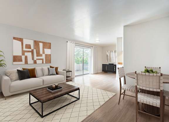 A modern living room with a white couch, a coffee table, and a large painting on the wall.