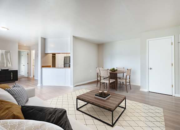 A modern living room with a white sofa and a coffee table.