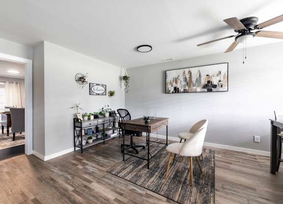 A room with a ceiling fan and a table with chairs.at Lauradale, Jacksonville, NC 28540