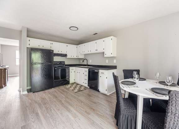 A modern kitchen with a dining table set for two.at Lauradale, Jacksonville