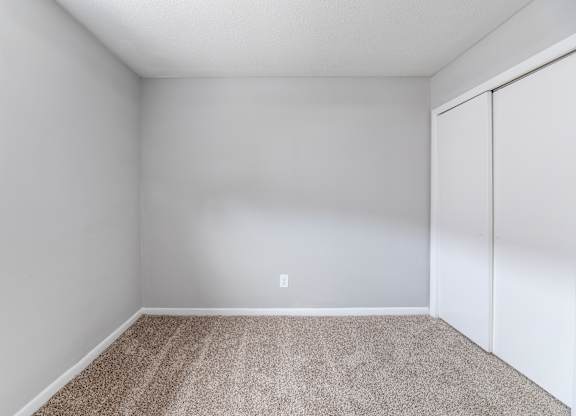 A room with a carpeted floor and a white wall.at Lauradale, Jacksonville