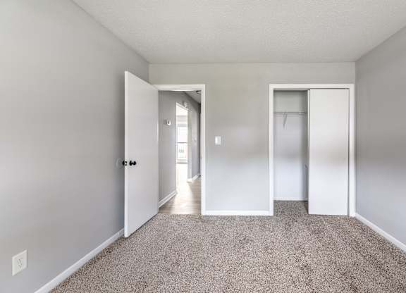 A room with a carpeted floor and two doors.at Lauradale, Jacksonville, 28540