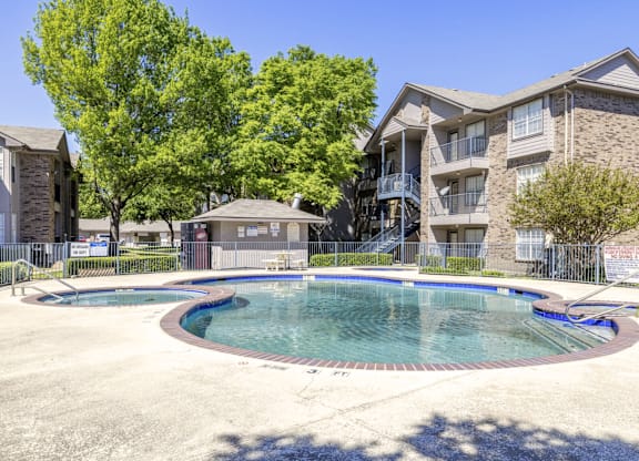 A swimming pool in front of a residential building.
