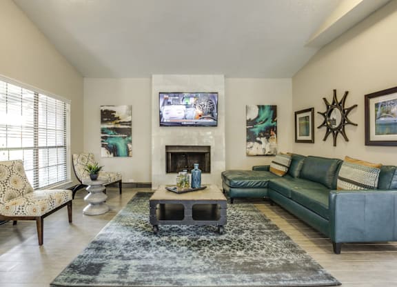 A living room with a fireplace and a television on the wall.