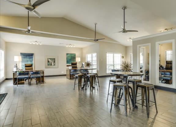 A spacious room with a bar area and a dining table.