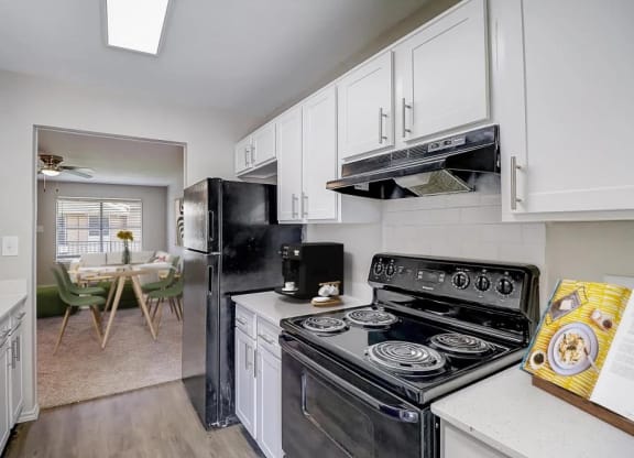 a kitchen with a stove and a refrigerator