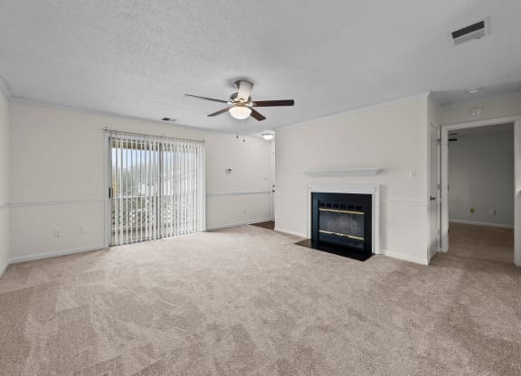 living room with fireplace , ceiling fan, and large patio window at Rosewood at Colony Square, Rocky Mount, NC
