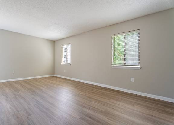 A room with a window and a wooden floor. at Rosen at North Hills, Raleigh