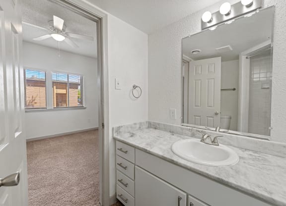 an empty bathroom with a sink and a mirror