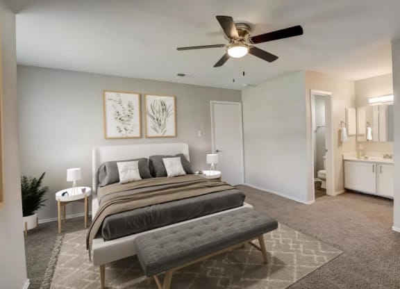 a bedroom with a bed and a ceiling fan