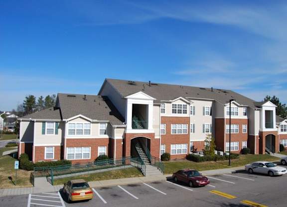 A large building with a parking lot in front of it.