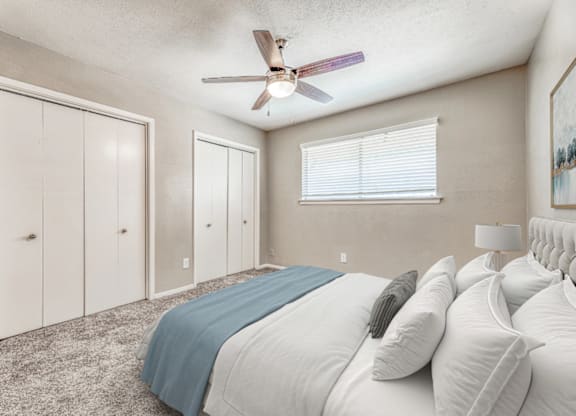 Spacious bedroom with dual closets and carpeting at Northwood Heights Apartments, Texas