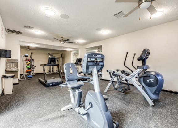 A well-equipped gym with treadmills, elliptical machines, and other exercise equipment.