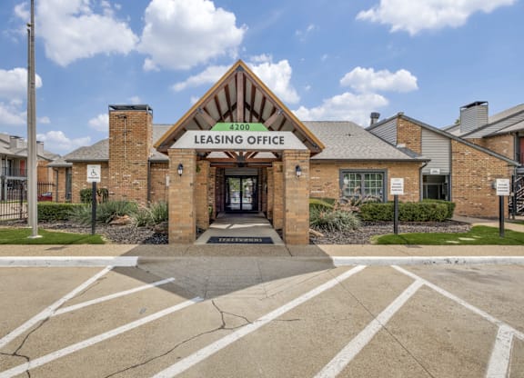 The image shows a brick building with a sign that reads