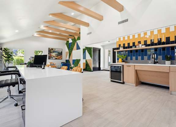 A modern office with a white reception desk and a black office chair. at Anson at North Hills, North Carolina, 27604
