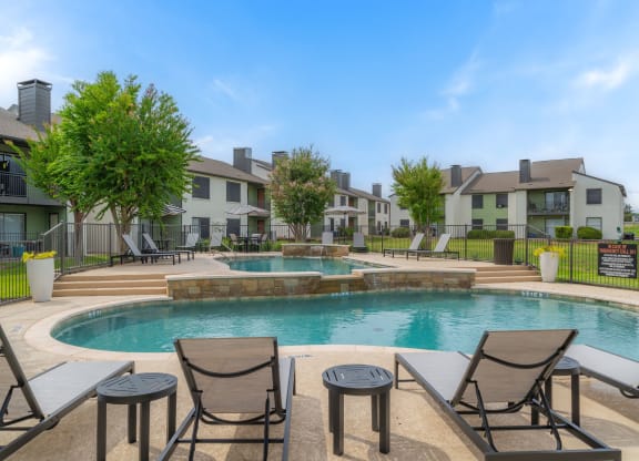 the preserve at ballantyne commons pool with chairs and apartment buildings