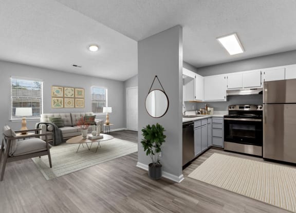 the living room and kitchen of an apartment with a couch and a table at Bennett, Greenville, 27858
