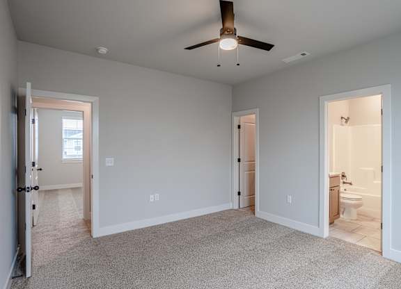 A spacious room with a ceiling fan and carpeted floor at Cedar Crest Apartments, Farmington