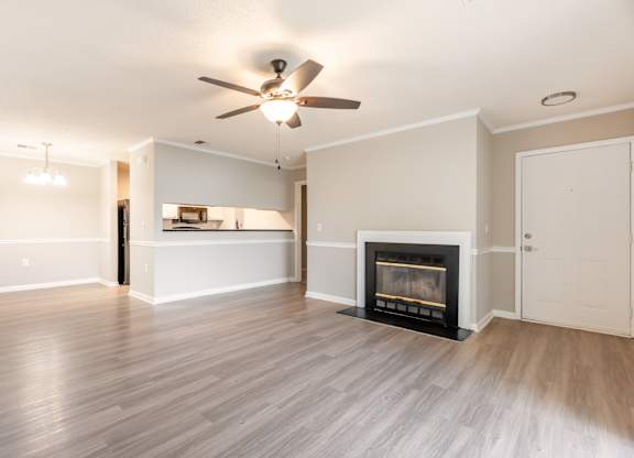 A living room with a fireplace and a ceiling fan. at Rosewood at Colony Square, North Carolina, 27804