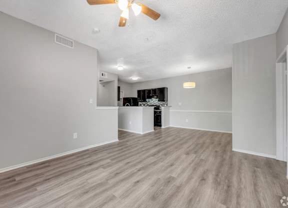 A room with a ceiling fan and lighting fixtures.