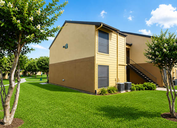 Two story apartment building with exterior staircase at Ridgeview Apartments, Sherman, TX