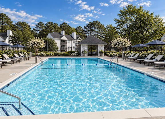 A large swimming pool with a gazebo in the background.