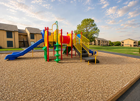 Colorful playground equipment with slides and climbing features at Ridgeview Apartments, Sherman, TX 75092