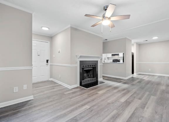 living room with a fireplace and ceiling fan  at Henley, North Carolina, 28311