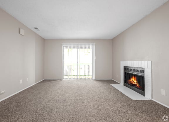 an empty living room with a fireplace