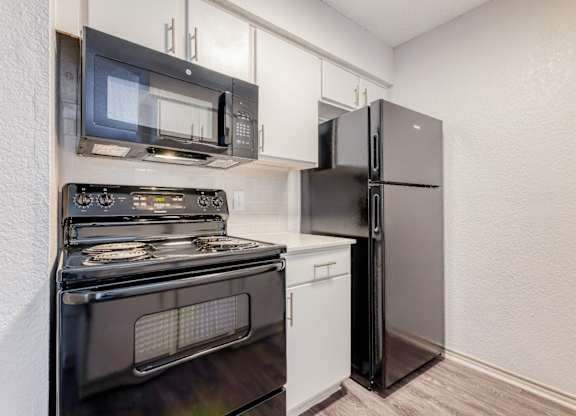 a kitchen with stainless steel appliances and a refrigerator