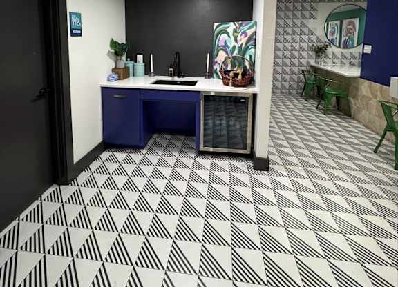 A bathroom with a black and white tiled floor.