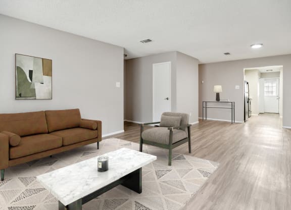 a living room with a couch and chairs and a table