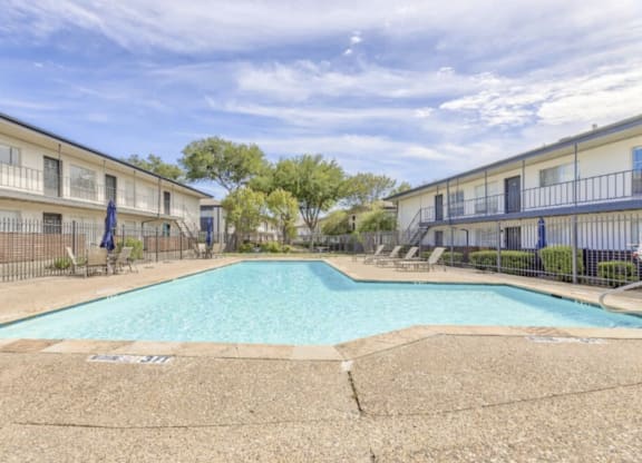 our apartments have a swimming pool and a building with trees