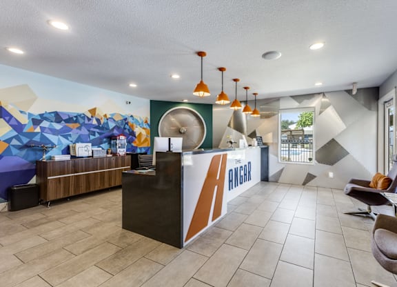 A reception area with a colorful mural on the wall.