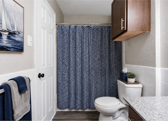 Bathroom with granite countertop and modern fixtures at Ridgeview Apartments, Sherman