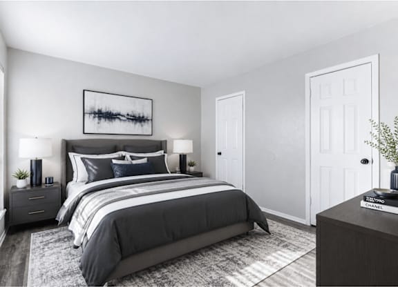 Modern bedroom with dark furniture and neutral decor at Ridgeview Apartments, Sherman, TX