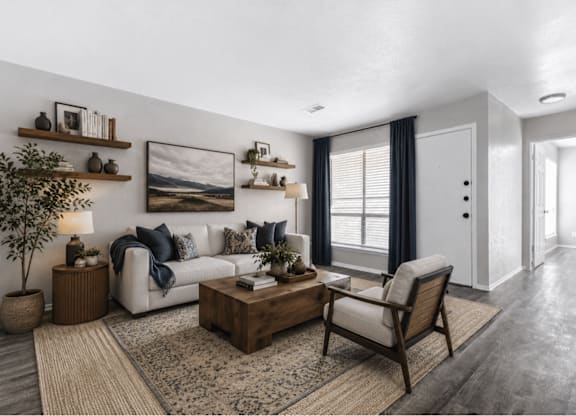 Living room with wood shelving and neutral furnishings at Ridgeview Apartments, Sherman, Texas