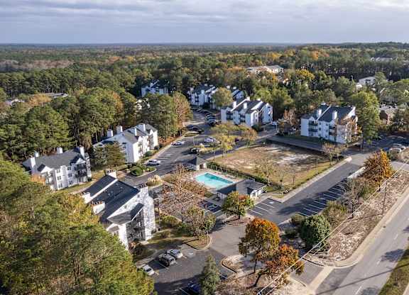 an aerial view of a neighborhood with houses and a road