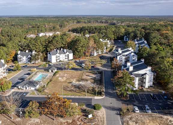 a aerial view of a neighborhood with houses and a swimming pool