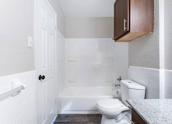 Bathroom with tub shower combo and wall cabinet at Ridgeview Apartments, Sherman, 75092