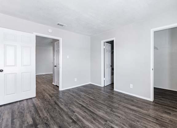 Empty room with multiple doorways and vinyl flooring at Ridgeview Apartments, Texas