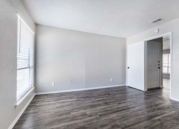 Spacious living room with window and hardwood flooring at Ridgeview Apartments, Sherman, 75092