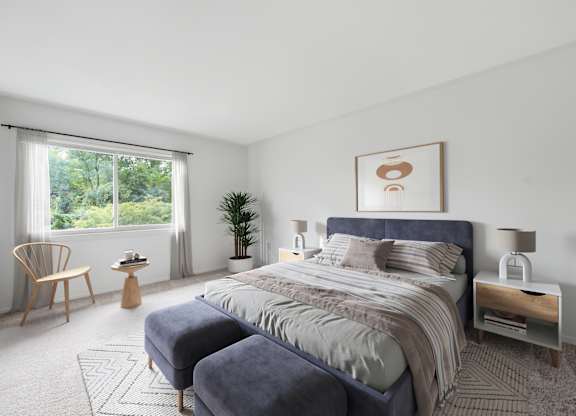 A bedroom with a large bed and a chair by the window.