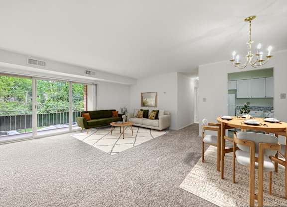 A living room with a dining table and chairs.