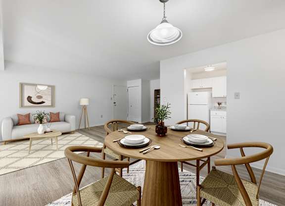 A dining room with a round table set for four.