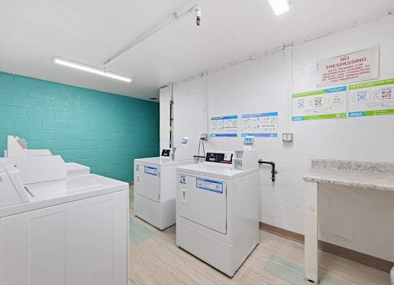 A room with a blue wall and a white sink.