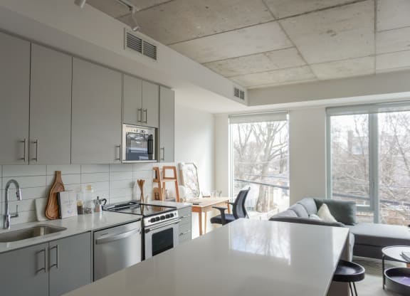 an open kitchen and living room with a large window