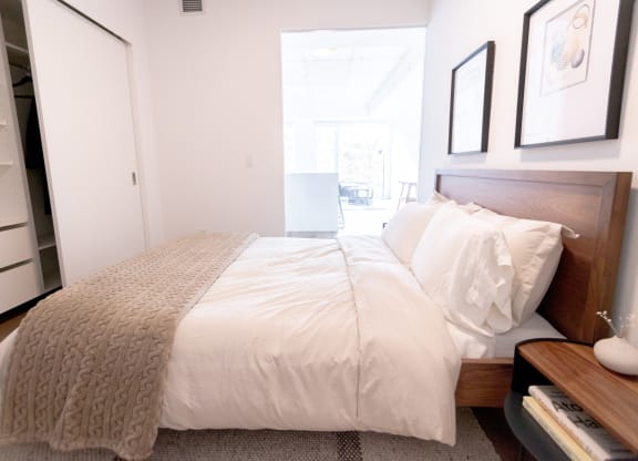 a bedroom with a bed and a large window
