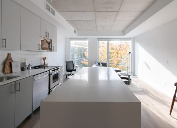 a kitchen and living room with a large island in the middle
